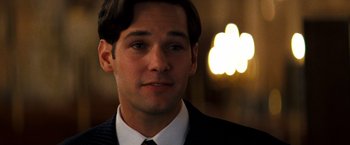 Movie still from “Romeo + Juliet” (1996), directed by Baz Luhrmann – A person wearing a suit and tie; Close Up shot, Over the shoulder angle