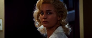 Movie still from “Romeo + Juliet” (1996), directed by Baz Luhrmann – A person with blonde hair; Close Up shot, Over the shoulder angle