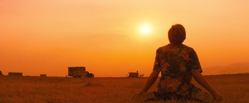 Movie still from “Romeo + Juliet” (1996), directed by Baz Luhrmann – A person standing in the middle of an open field at sunset; Extreme Wide shot, Over the shoulder angle