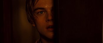 Movie still from “Romeo + Juliet” (1996), directed by Baz Luhrmann – A man's face in a dark room; Close Up shot, Over the shoulder angle