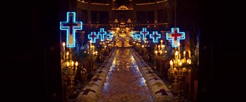 Movie still from “Romeo + Juliet” (1996), directed by Baz Luhrmann – A church is lit up with candles and crosses; Extreme Wide shot, High angle
