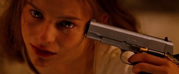 Movie still from “Romeo + Juliet” (1996), directed by Baz Luhrmann – A woman holding a gun up to her head; Extreme Close Up shot, High angle