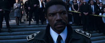 Movie still from “Romeo + Juliet” (1996), directed by Baz Luhrmann – A person wearing a suit and tie; Close Up shot, High angle