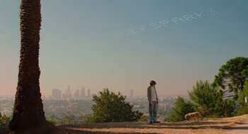 Movie still from “Ruby Sparks” (2012), directed by Valerie Faris – A man standing on a hill looking out at a city; Extreme Wide shot, Over the shoulder angle