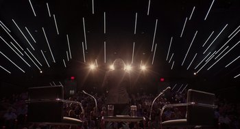 Movie still from “Ruby Sparks” (2012), directed by Valerie Faris – A man standing in front of an audience at a concert; Extreme Wide shot, Low angle