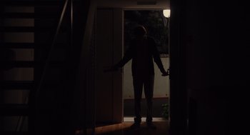 Movie still from “Ruby Sparks” (2012), directed by Valerie Faris – A person standing in a dark room with their arms outstreched; Wide shot, Low angle