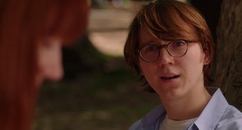 Movie still from “Ruby Sparks” (2012), directed by Valerie Faris – A person with glasses is looking at a camera; Close Up shot, Over the shoulder angle