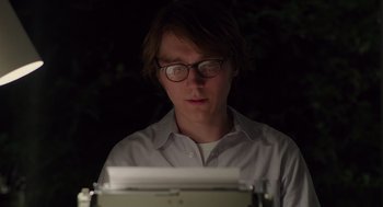 Movie still from “Ruby Sparks” (2012), directed by Valerie Faris – A man with glasses is looking at a typewriter; Close Up shot, Low angle