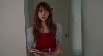Movie still from “Ruby Sparks” (2012), directed by Valerie Faris – A woman in a red apron holding a pan; Close Up shot, Over the shoulder angle
