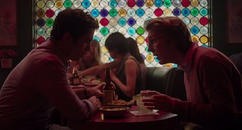 Movie still from “Ruby Sparks” (2012), directed by Valerie Faris – A couple of people sitting at a table with food and drinks; Medium shot, Over the shoulder angle
