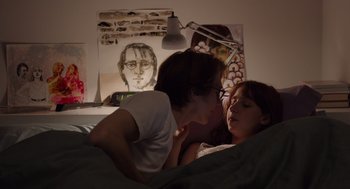 Movie still from “Ruby Sparks” (2012), directed by Valerie Faris – Two people in a bed with a painting on the wall behind them; Medium shot, Over the shoulder angle
