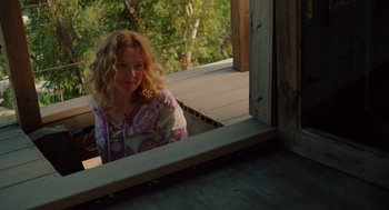 Movie still from “Ruby Sparks” (2012), directed by Valerie Faris – A woman sitting on a porch looking out a window; Medium shot, High angle
