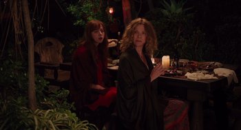 Movie still from “Ruby Sparks” (2012), directed by Valerie Faris – Two women sitting at a table with a candle in front of them; Medium shot, High angle