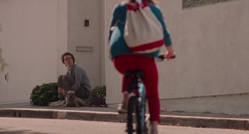Movie still from “Ruby Sparks” (2012), directed by Valerie Faris – A woman riding a bike down a street with a man sitting next to her; Wide shot, Over the shoulder angle