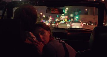 Movie still from “Ruby Sparks” (2012), directed by Valerie Faris – Two people in the back seat of a car at night; Medium shot, Over the shoulder angle