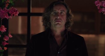 Movie still from “Ruby Sparks” (2012), directed by Valerie Faris – A man with long hair and a black shirt; Close Up shot, Low angle