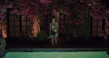 Movie still from “Ruby Sparks” (2012), directed by Valerie Faris – A woman standing in front of a pool at night; Wide shot, High angle