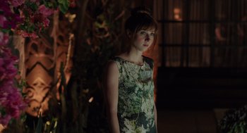 Movie still from “Ruby Sparks” (2012), directed by Valerie Faris – A woman in a floral dress standing next to a tree; Medium shot, Over the shoulder angle