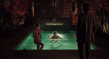 Movie still from “Ruby Sparks” (2012), directed by Valerie Faris – Two women and a man in a pool at night; Wide shot, Over the shoulder angle