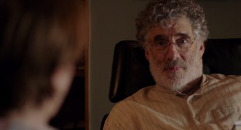 Movie still from “Ruby Sparks” (2012), directed by Valerie Faris – An older man sitting in an office chair; Close Up shot, Over the shoulder angle