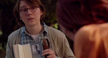 Movie still from “Ruby Sparks” (2012), directed by Valerie Faris – A young man holding a pair of pliers and a book; Close Up shot, Over the shoulder angle