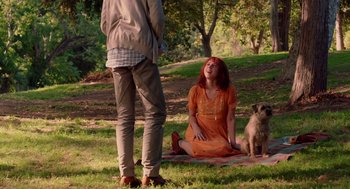 Movie still from “Ruby Sparks” (2012), directed by Valerie Faris – A woman sitting on the ground in front of a dog; Wide shot, Over the shoulder angle