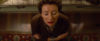 Movie still from “Saving Mr. Banks” (2013), directed by John Lee Hancock – An older woman is sitting with her arms folded around her chest; Close Up shot, Overhead angle
