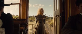 Movie still from “Saving Mr. Banks” (2013), directed by John Lee Hancock – A woman standing on a train looking out the window; Wide shot, Over the shoulder angle