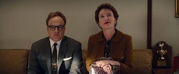 Movie still from “Saving Mr. Banks” (2013), directed by John Lee Hancock – A man and a woman sitting next to each other on a couch; Medium shot, Low angle