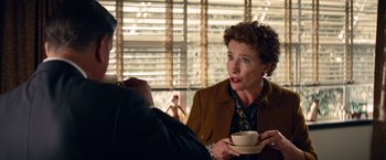 Movie still from “Saving Mr. Banks” (2013), directed by John Lee Hancock – An older woman is holding a coffee cup; Medium shot, Over the shoulder angle