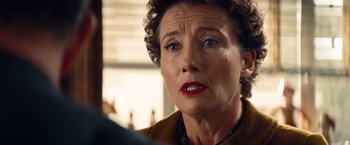 Movie still from “Saving Mr. Banks” (2013), directed by John Lee Hancock – An older woman looking at the camera with a serious look on her face; Close Up shot, Over the shoulder angle