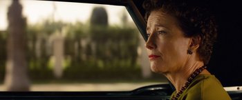Movie still from “Saving Mr. Banks” (2013), directed by John Lee Hancock – An older woman sitting in the driver's seat of a car looking out the window; Close Up shot, Over the shoulder angle