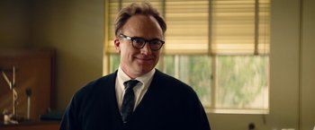 Movie still from “Saving Mr. Banks” (2013), directed by John Lee Hancock – A man in a suit and tie standing in front of a window; Close Up shot, Over the shoulder angle