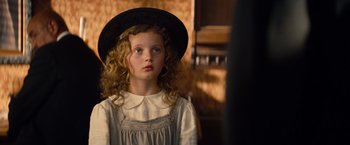 Movie still from “Saving Mr. Banks” (2013), directed by John Lee Hancock – A young girl wearing a black hat and a white shirt; Close Up shot, Over the shoulder angle