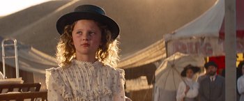 Movie still from “Saving Mr. Banks” (2013), directed by John Lee Hancock – A little girl wearing a hat standing in a field; Close Up shot, Low angle