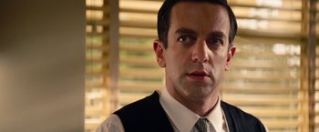 Movie still from “Saving Mr. Banks” (2013), directed by John Lee Hancock – A person wearing a suit and tie; Close Up shot, Over the shoulder angle