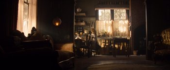 Movie still from “Saving Mr. Banks” (2013), directed by John Lee Hancock – A woman sitting at a table in a kitchen; Wide shot, High angle