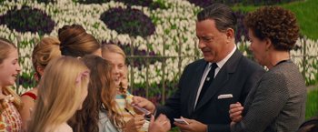 Movie still from “Saving Mr. Banks” (2013), directed by John Lee Hancock – A group of people standing next to each other; Medium shot, Over the shoulder angle