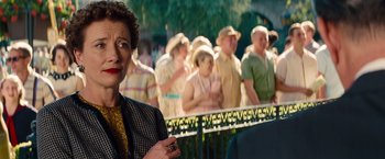 Movie still from “Saving Mr. Banks” (2013), directed by John Lee Hancock – An older woman standing in front of a group of older people; Close Up shot, Over the shoulder angle