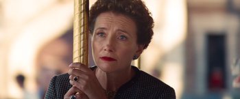 An older woman with blue eyes is looking at the camera