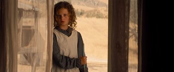 Movie still from “Saving Mr. Banks” (2013), directed by John Lee Hancock – A young girl standing in front of an open door; Close Up shot, Over the shoulder angle