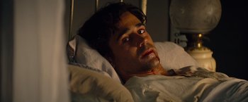 Movie still from “Saving Mr. Banks” (2013), directed by John Lee Hancock – A person laying in a bed with blood on his face; Close Up shot, High angle