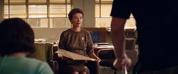 Movie still from “Saving Mr. Banks” (2013), directed by John Lee Hancock – An older woman sitting in an office chair holding a piece of paper; Medium shot, Over the shoulder angle