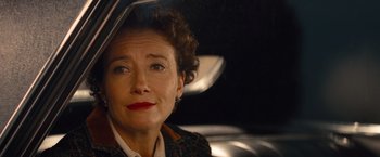 Movie still from “Saving Mr. Banks” (2013), directed by John Lee Hancock – An older woman sitting in the back seat of a car; Close Up shot, Over the shoulder angle