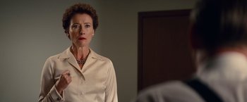 Movie still from “Saving Mr. Banks” (2013), directed by John Lee Hancock – A woman standing in front of a mirror in front of a door; Close Up shot, Over the shoulder angle