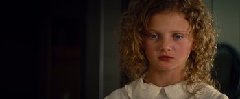 Movie still from “Saving Mr. Banks” (2013), directed by John Lee Hancock – A young girl with long curly hair wearing a white shirt; Close Up shot, Low angle
