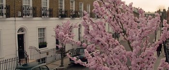 Movie still from “Saving Mr. Banks” (2013), directed by John Lee Hancock – A car parked on the side of the road next to a tree; Extreme Wide shot, High angle