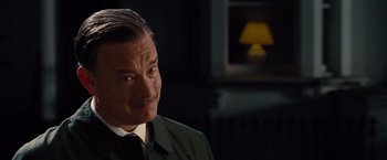 Movie still from “Saving Mr. Banks” (2013), directed by John Lee Hancock – A person wearing a suit and tie; Close Up shot, Over the shoulder angle