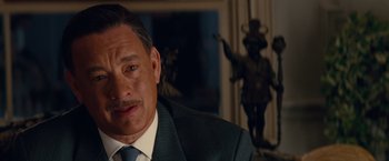 Movie still from “Saving Mr. Banks” (2013), directed by John Lee Hancock – A person wearing a suit and tie; Close Up shot, Over the shoulder angle