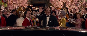 Movie still from “Saving Mr. Banks” (2013), directed by John Lee Hancock – A man in a tuxedo waving to the crowd; Medium shot, Over the shoulder angle